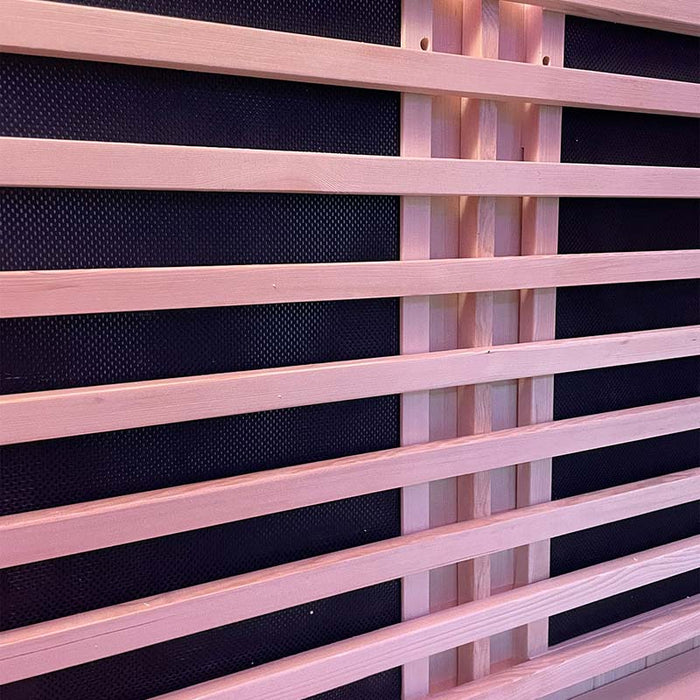 The infrared panels behind the wooden slats in the Insignia Outdoor Infrared Sauna offer low electromagnetic output heating for a soothing and energy-efficient experience.