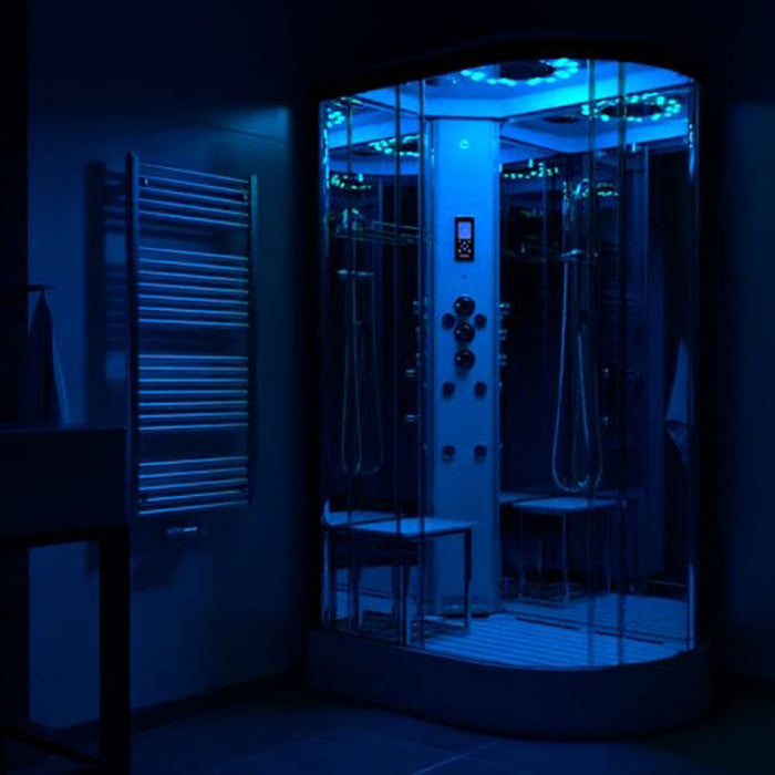 Insignia Platinum 1200 x 800 LH steam shower glowing with blue LED lights, creating a calming bathroom ambience.