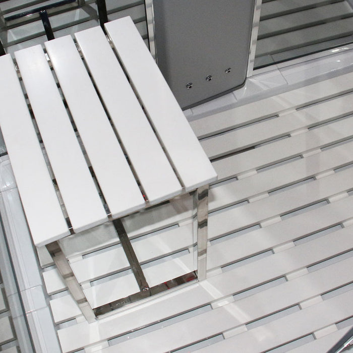Close-up of Insignia 1050 x 850 steam shower interior showing white slatted stool and acrylic flooring for a clean, modern spa look.
