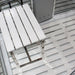 Minimalist white acrylic stool and floor tray featured in the Insignia Platinum Steam Shower 1150 x 850 cabin.