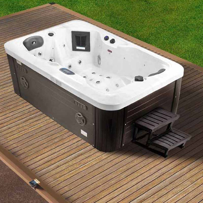 Jaquar Nuovo Spa on wooden decking with steps, showcasing hydrotherapy jets and touch panel.