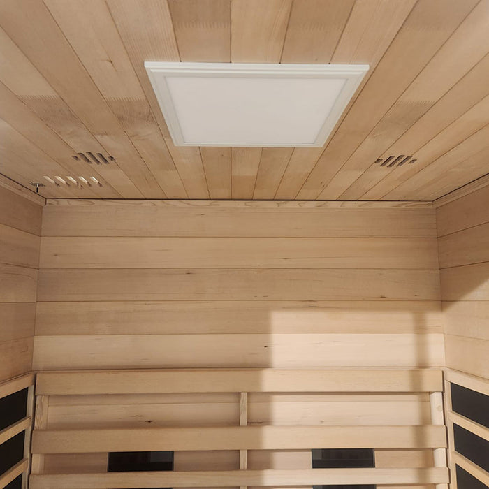 Image of the sauna ceiling with soft-glow LED lighting panel for chromotherapy, accompanied by wooden ventilation slots.