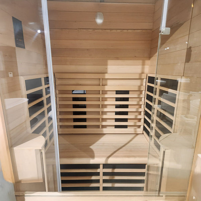Spacious interior of the Jaquar Paire sauna for two users, with full-length heating panels lining the sides and back wall.