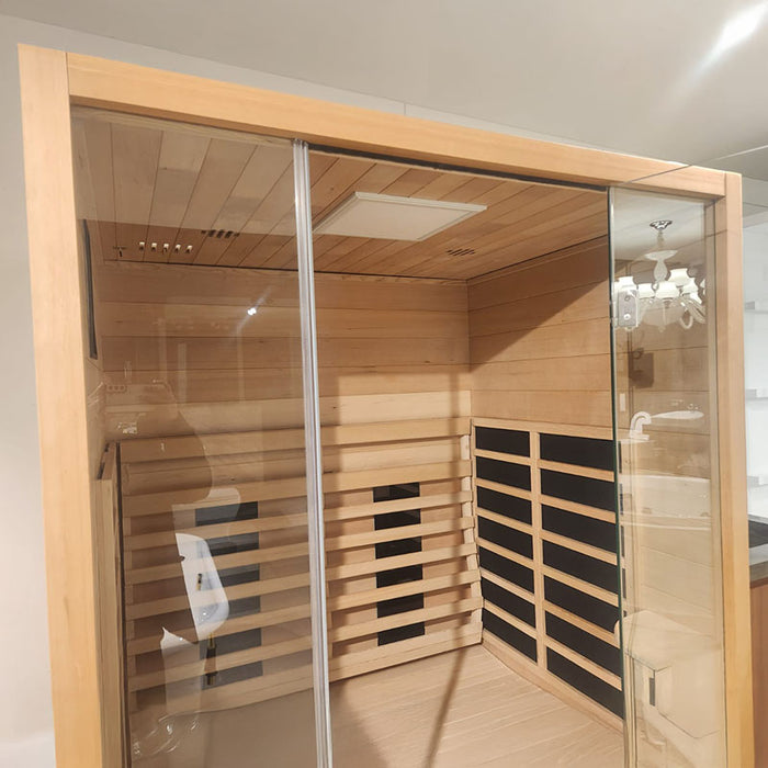 Interior perspective of the Jaquar 2-seater infrared sauna showing dual-side heater panels and LED ceiling light, viewed through the full glass front.