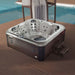 Jaquar Polaris Spa hot tub on wooden decking with steps with a pool in the background.