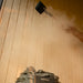 Water being poured over HARVIA sauna heater inside the Jonas Classic 4-person cabin, producing steam for traditional sauna experience.
