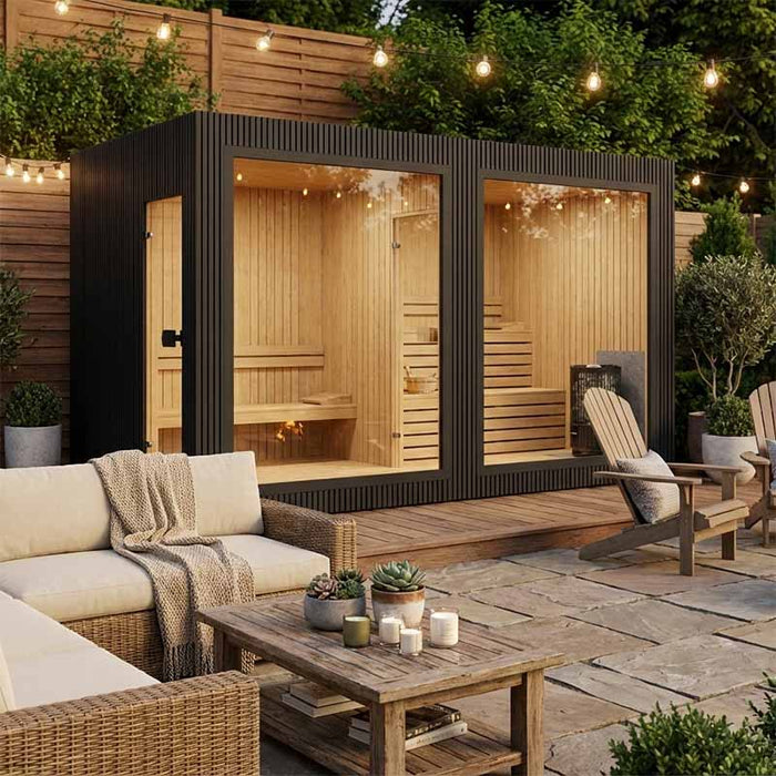 Stylish black Jonas Grand 8–10 person lounge sauna featured in a cosy backyard setting with string lights, fire pit, and outdoor lounge furniture.