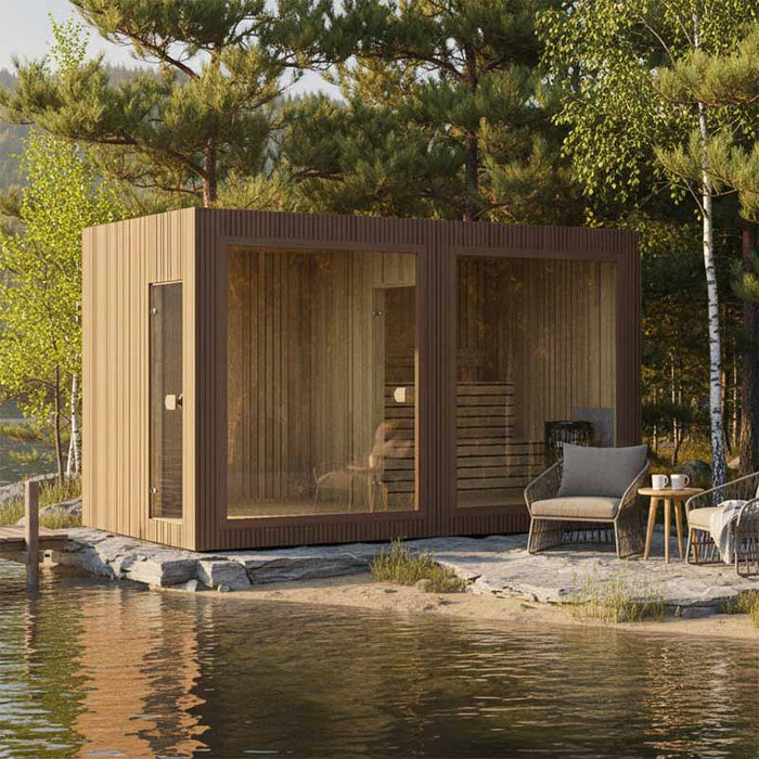 Contemporary Jonas Grand 8–10 person sauna cabin placed on a lakeside deck with rattan seating, offering a tranquil wellness escape in nature.