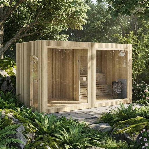 Jonas Grand 8–10 person sauna with vertical wood cladding beautifully integrated into a lush garden landscape with moss-covered rocks and greenery.