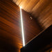 Interior ceiling view of the Jonas Grand 8-person sauna showing vertical ambient light strip along the corner wall and wooden panelling.