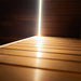 Interior detail of the Jonas Grand 8-person outdoor sauna with a view of the top bench and integrated ambient lighting feature.
