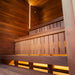 Warmly lit interior of the Jonas Grand 8-person sauna with wooden bench seating, ambient lighting, and a relaxing atmosphere.