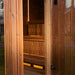 Open door view into the Jonas Grand 8-person sauna revealing inviting warm lighting and precision-crafted timber seating.