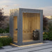 Stylish grey Jonas Mini 3-person sauna installed in a landscaped garden patio, offering an elegant outdoor wellness experience.