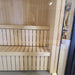 Interior view of the Jonas Mini 3-person outdoor sauna with smooth, vertical slatted bench seating and high-grade timber finish.