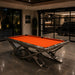 Luxury Koralturk Aristo billiards table with orange cloth and sculptural metallic legs in a contemporary interior.