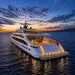 Luxury superyacht at sunset featuring the Koralturk Atlantis Gyroscopic Pool Table in its open-air entertainment area.