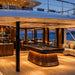Koralturk Atlantis Gyroscopic Pool Table illuminated within a luxury superyacht entertainment lounge overlooking the sea.