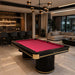 Koralturk Elit Pool Table with vibrant pink cloth, black frame, fluted pedestal bases and gold accents in a luxury games room.