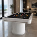 Koralturk Elit Pool Table with white ribbed pedestal bases, black playing cloth and billiard balls in a luxury living room.