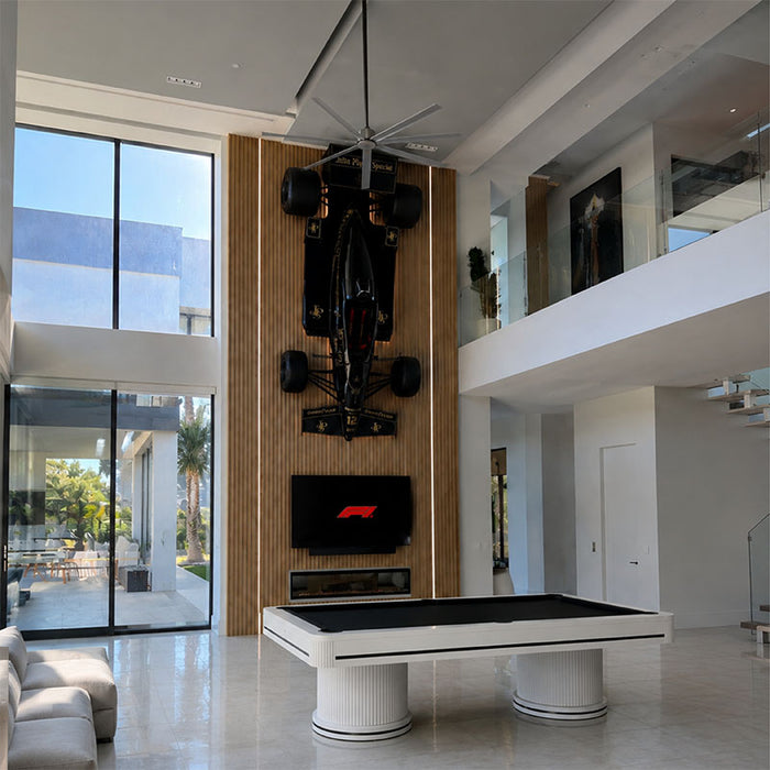 Koralturk Elit Pool Table with black cloth and white fluted pedestal bases displayed in a spacious modern luxury home.