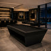 Koralturk Kaplankaya luxury billiards table in an all-black finish with angular geometric base, styled in an elegant contemporary games room.