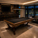 Koralturk Legnora billiards table with black cloth and sculptural timber base in a luxurious modern entertainment room.