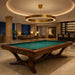 Koralturk Legnora Pool Table with green cloth and distinctive wooden base beneath a statement light in a luxury lounge interior.