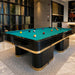 Koralturk Trapeza Pool Table with green cloth, glossy black frame, gold detailing and billiard balls in a luxury interior.