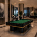 Koralturk Trapeza Pool Table with green cloth, polished black frame and gold accents displayed in an elegant hotel lobby.