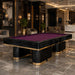Koralturk Trapeza billiards table with purple cloth, glossy black body and gold detailing in a contemporary luxury lobby.