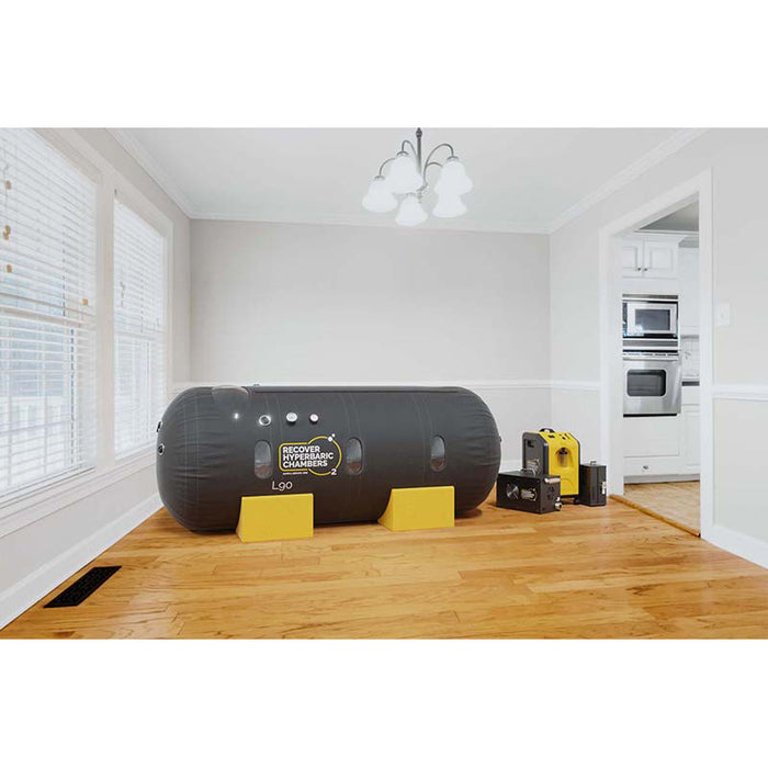 Angled view of Hyperbaric L90 chamber with equipment in home interior.