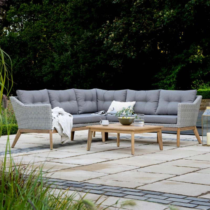 Front view of Larissa Corner Seating Set in backyard with a wooden coffee table.