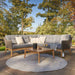 Front view of Larissa Outdoor Corner Seating Set arranged in a garden setting with a wooden coffee table.