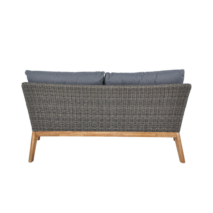 The back view of the Larissa Outdoor Seating Set’s two-seater sofa, showcasing the woven rattan and sturdy acacia wood frame.