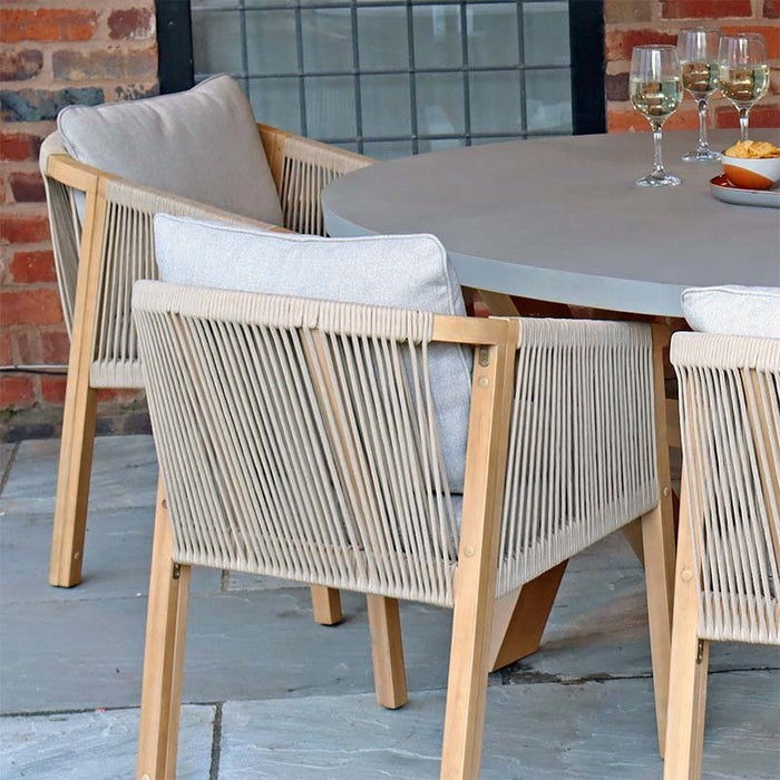 A detailed view showcasing the elegant rope backrest and plush grey cushions of the chairs, part of the Luna 6 Seater Concrete Table Dining Set.