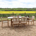 Front view of the Luna 6 Seater Rectangular Concrete Dining Set with Rope Stacking Chairs, set against a scenic outdoor background.