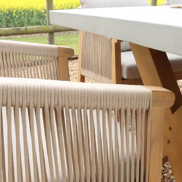 A close-up of the rope armrest and wooden frame, highlighting the premium craftsmanship of the Luna Dining Set's seating.