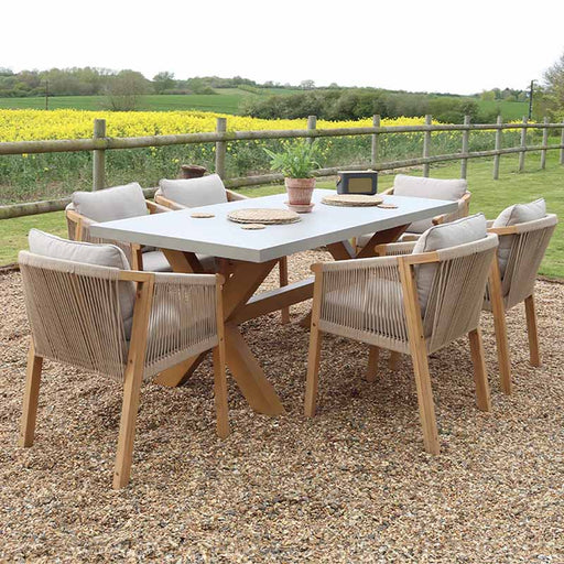 The full Luna 6 Seater Dining Set with a rectangular concrete table and rope dining chairs, styled in an outdoor garden setting.