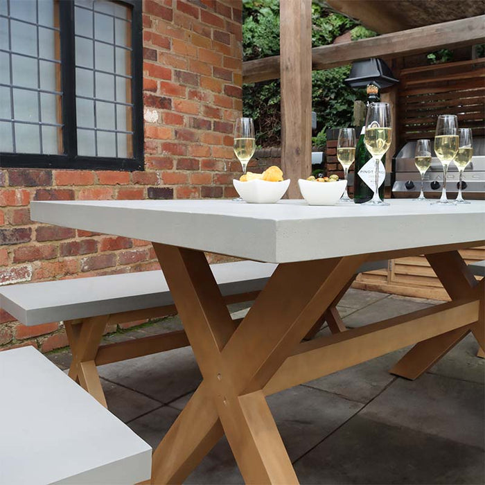 Side view of the Luna 8 Seater Dining Table highlighting the contemporary concrete design and wooden bench.