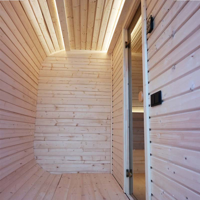 Wooden interior with glass door and thermometer of the Luna Outdoor Sauna. 