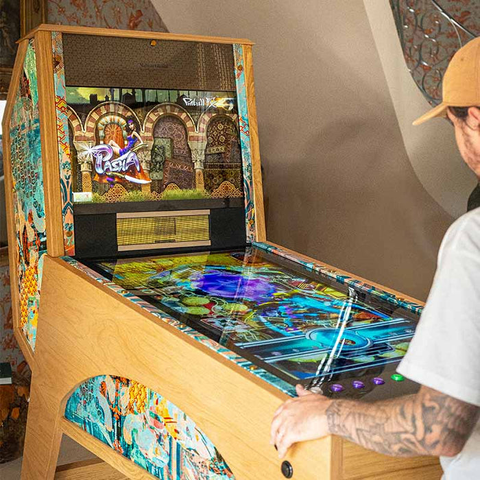 Player operating Maison Roshi Jiraiya Pinball Machine with Pasha themed Pinball FX3 game on display and colourful side panels.