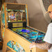 Player operating Maison Roshi Jiraiya Pinball Machine with Pasha themed Pinball FX3 game on display and colourful side panels.