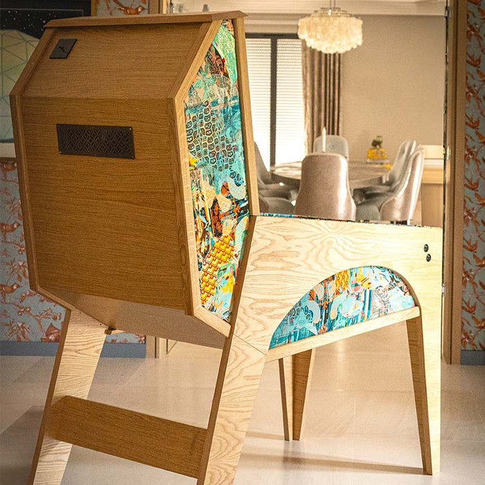 Close-up rear side panel of Maison Roshi Jiraiya Pinball Machine with vibrant turquoise and orange patterned artwork and wooden cabinet.