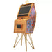 Maison Roshi Senpai V3 Lite arcade cabinet with wooden frame, gold legs, and feather headdress artwork on black side panel, featuring Nintendo Switch dock.