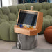 Maison Roshi Sensei V1 arcade console with vibrant blue and yellow controls, set atop a sculptural metallic base, blending vintage gaming with modern interior style.