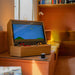 Maison Roshi Sensei V1 classic arcade cabinet placed in a stylish living room, displaying vintage Super Mario gameplay with dual joystick controls and warm lighting.