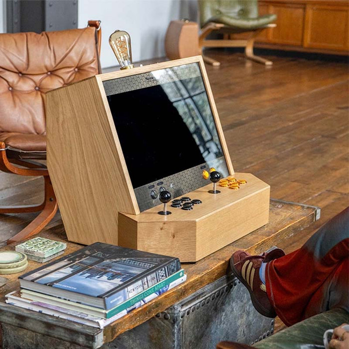 Maison Roshi Sensei V2 arcade machine in a vintage-style lounge with black and orange controls, crafted from natural wood for a timeless retro gaming look.