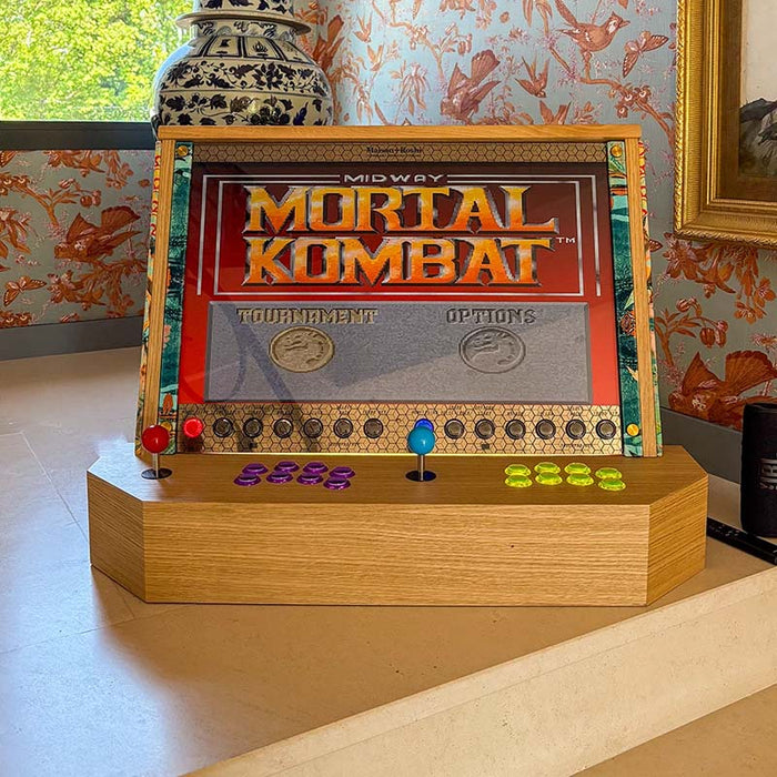 Maison Roshi Sensei V3F Arcade Cabinet Wallasea featuring Mortal Kombat gameplay, with bright dual joysticks and detailed side art, placed in a stylish room.