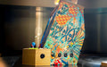 Side view of the Maison Roshi Sensei V3F Arcade Cabinet Wallasea highlighting intricate floral and abstract patterns on the panel with USB and power ports.